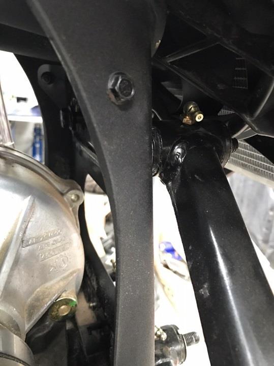 Remove the front shocks from the upper arm using an 18mm wrench and socket and tie up out of the way. 3. Drill the rivets holding on the brake line clamps from the arm and the ones on the frame.