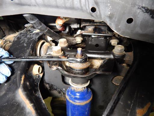 Note: It may be necessary to keep he shock absorber from turning by holding the shock with a 6mm open end wrench.