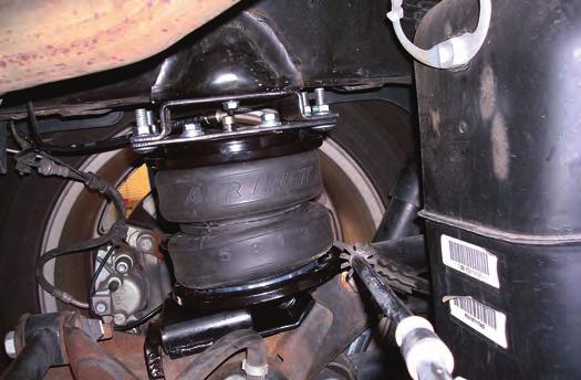 Remove the air line heat shield sleeve in the hose heat shield kit and install on the right side (passenger side) air line where it attaches to the fitting on the upper bracket (fig. 30).
