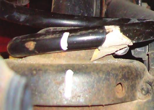 2. Mark the bottom of the right-hand and left-hand coil springs and lower spring seat mounts with
