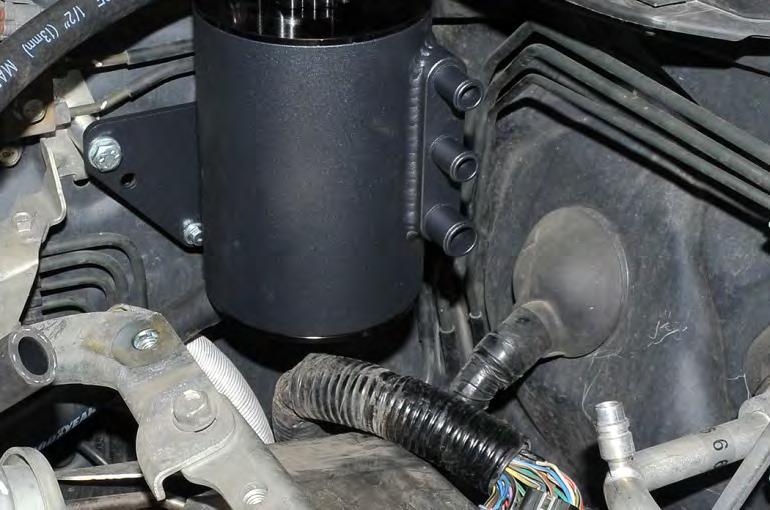 28. Use a 10mm socket and ratchet to remove the (1) 10mm bolt from the power steering line bracket located on the