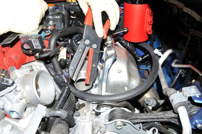 The line will route over the transmission, thru the intercooler support bracket and finally