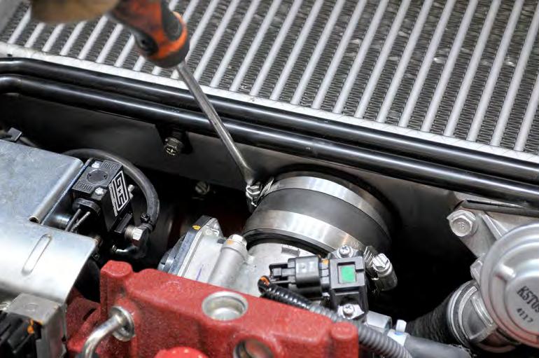 Grab the intercooler by the sides and carefully wiggle it out of the engine bay.