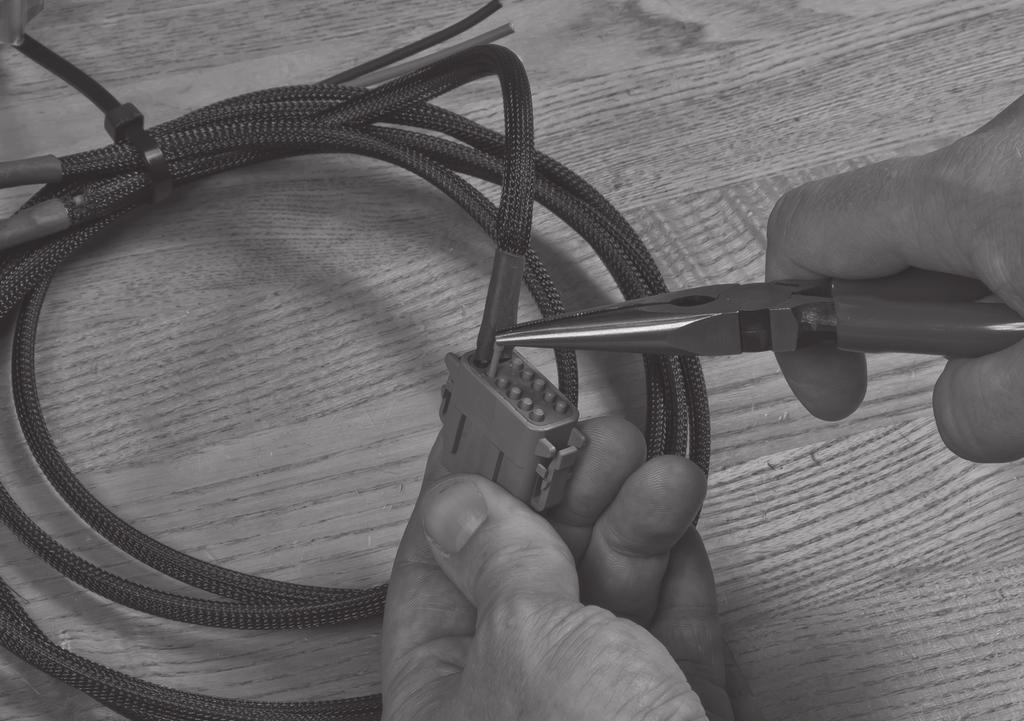 A minimum length of 15.2 to 30.4 cm (6 to 12 in) is recommended. Mark each cable where it can be trimmed.