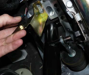 By design its contact point on the pedal arm is adjustable from the factory. With the pedal in its normal resting position, press on the brake light switch.