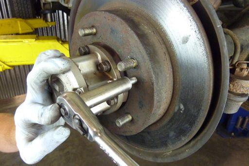 Caution: Never let a caliper hang by the brake hose. The hose can be weakened or damaged.