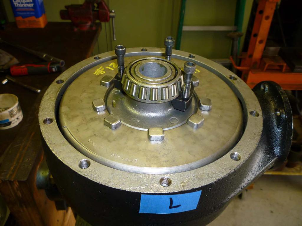 The left carrier bearing is being removed from the carrier hub using a specially made