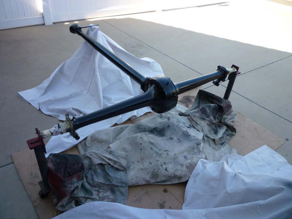 This photo shows the rear axle assembly being painted. Note the assembly is up-side-down in the roll around horizontal jig. This allows the complete bottom to be painted.