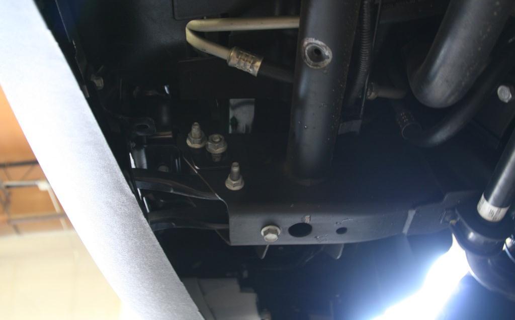 4. Remove 21mm nuts (2 per side) from the bolt strips holding the bumper brackets to the frame.