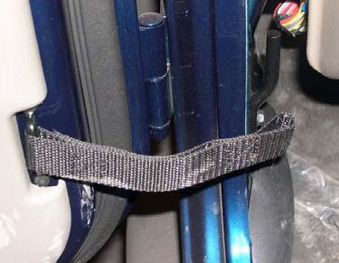 b. Open door and remove door restraint strap from pin and vehicle. Pin b.