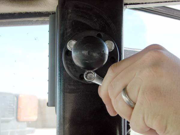 Installation Procedure Installation Procedure 1. The MacDon cab has three holes in the cab pillar on the right-hand side.