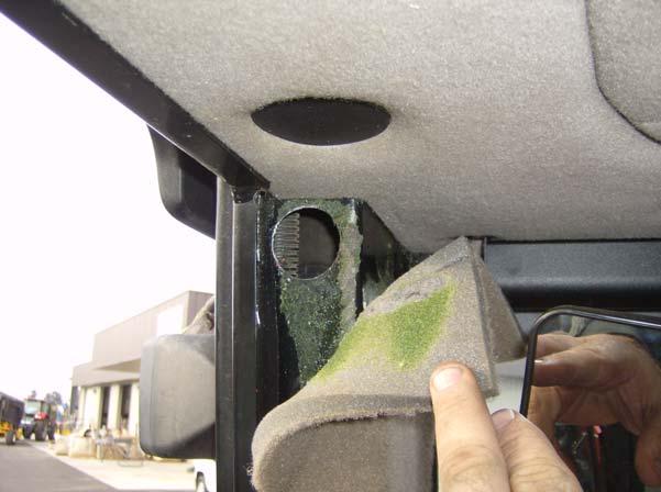 Prepare Cab Pillar for Cable Routing 2. Carefully pull back the foam upholstery from the front of the top right rear pillar to expose a punch out for a round hole.