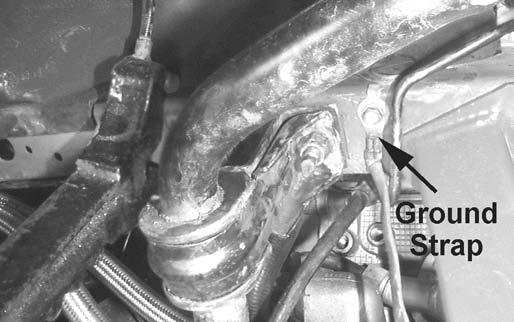 74. Remove the K-member brace, and install the engine. Gently lower the engine down onto the K-member, making sure not to pinch any lines or wires.
