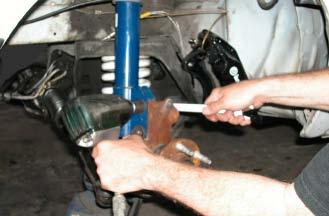 Loosen the front strut-to-spindle bolts, but do not remove them. 14.
