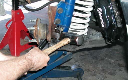 Loosen the lower ball joint nut until the top of the nut is flush with the top of