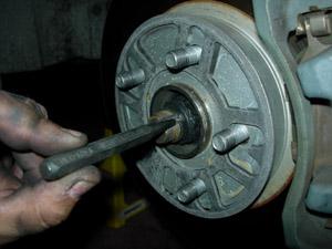 Step 5-D: Chisel out staked portion of passenger side axle nut to allow nut to turn.