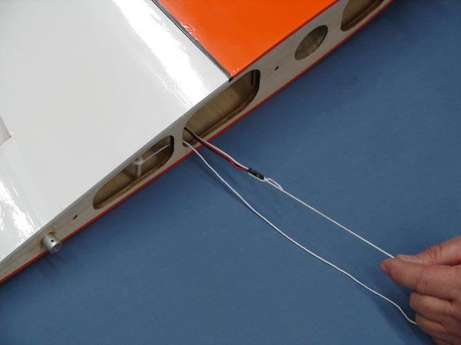 4. Remove the balsa stick with the pull string from the servo well and tie