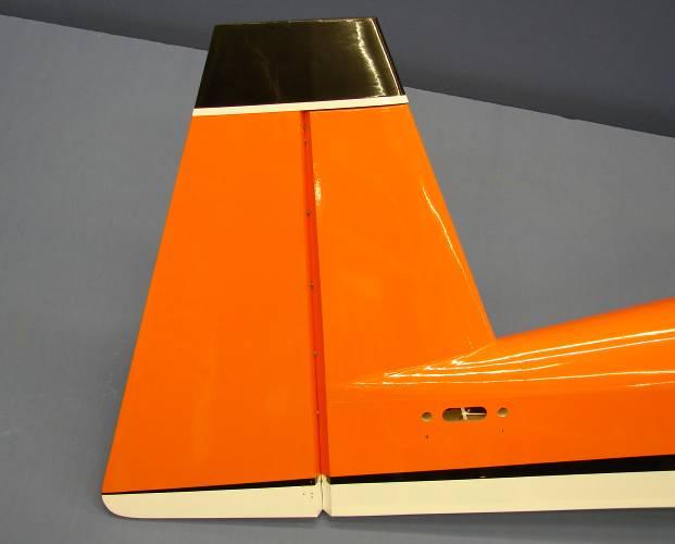 Carefully slide the rudder onto each hinge and against the trailing edge of the fin.