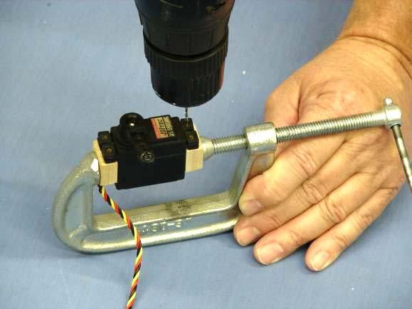 Use a C-clamp to hold the servo mounting blocks to the servo. 7.