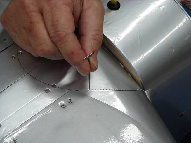 Use a T-Pin to poke holes in the covering along the