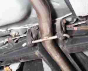 7) Take the PASSENGER SIDE muffler and slide the rubber insulator on to