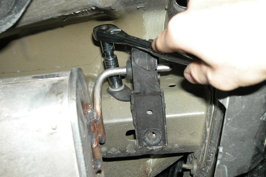 rear most rubber isolator above the passenger side muffler (See Fig. C). 4.