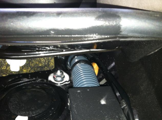 From inside the car, locate the large vehicle harness grommet on the left side. If accessible, cut the auxiliary wiring nipple off the grommet or cut ¼ slit in grommet.