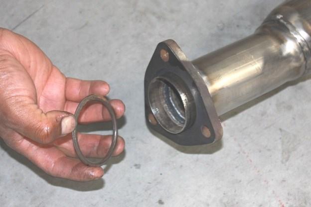 Insert Right Side Muffler Assembly, hangers into factory rubber isolators lightly tighten hardware on flange. (See Fig. 6 & 7) 4.