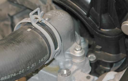 Relieve the pressure in the cooling system by removing the radiator reservoir cap fi rst.