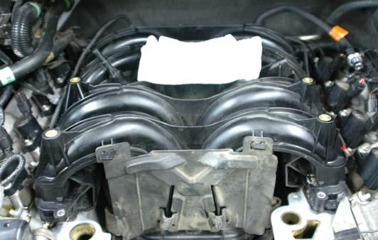Though the intake manifold is now loose, it cannot be removed from the engine as there are still