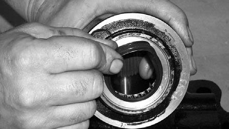 16. Install a new sector shaft oil seal in the sector shaft cover. When properly fitted the seal will ride between the roller bearing and cover.
