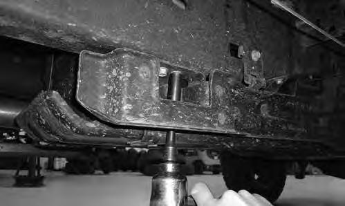 FIGURE 8 19. While supporting the skid plate, remove the two bolts going up into the frame at the rear of the skid plate.