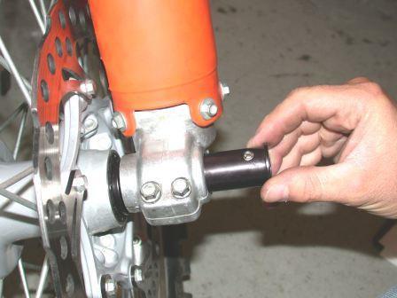 19. Slide the 26-mm Flanged Bushing onto the left-end of the Center Axle through the left fork fist by positioning the bushing with the set screw facing up, this will allow the bushing to slide over