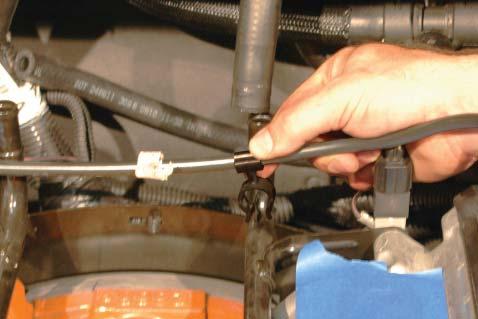 28. Remove the two heater hose clamps from the hard line tubes