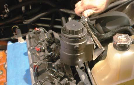 88. Install the intercooler reservoir mounting bracket assembly and secure using the removed nut using