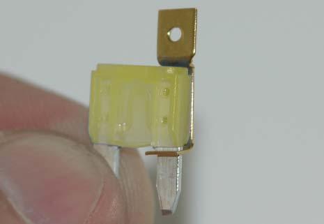 Cut a small notch in the raised seal of the fuse box cover to
