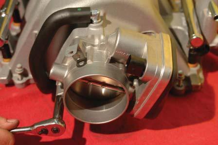Remove the throttle body using a 10mm wrench.