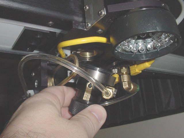 Pg. 2 of 10 Figure 2. Nozzle Assembly Removal 3. Set the nozzle assembly on the table and remove the gas assist tubing.