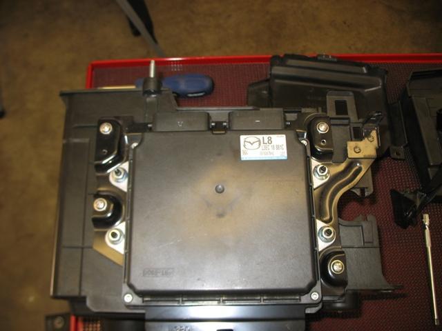3. With the cover removed, now remove the 4-10mm ECU mounting nuts, remove the ECU