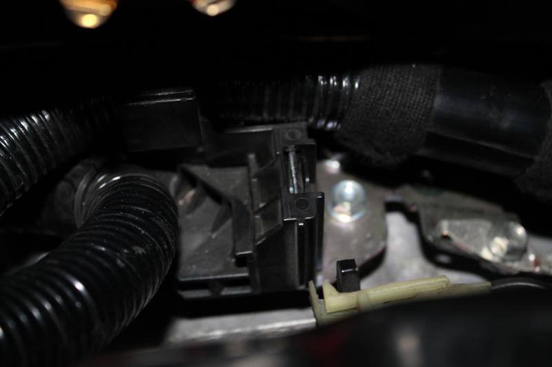 5. Disconnect the ECU wiring harness from the mounting bracket securing it to the transmission.