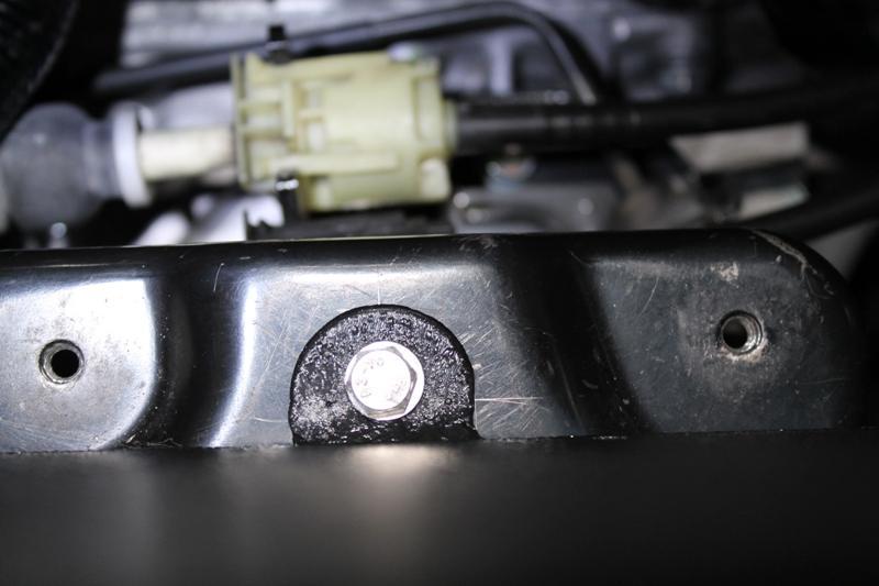 7. Using the included stainless bolt, two flat washer and lock nut, secure the passenger side of the battery box and tighten with a 10mm socket and 10mm wrench.