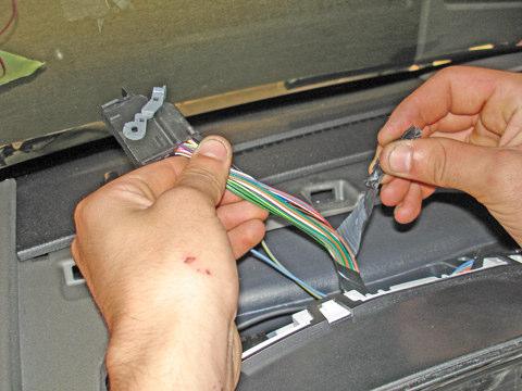 7. Remove the electrical tape from the harness to a distance of about six inches behind the connector (see Figure 7).