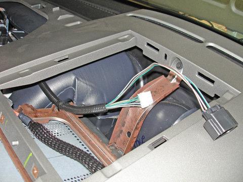 Secure the gauge pod end of the harness to the IP radio support
