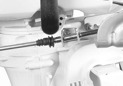 Install throttle cable in control cable holder. Cable housing groove engages holder.
