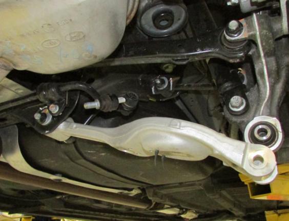 Carefully lower the transmission jack until the control arm swings