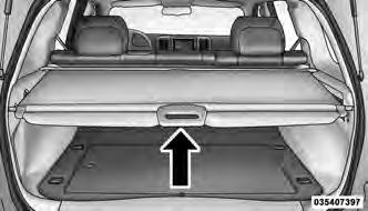 It will not prevent cargo from shifting or protect passengers from loose cargo. To cover the cargo area: 1. Grasp the cover at the center handle.
