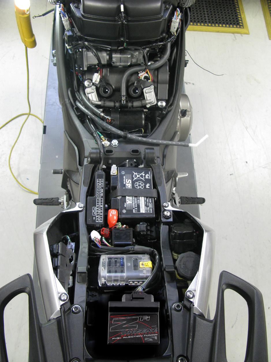 Plug main connector of the Bazzaz fuel harness to the fuel control unit and begin routing the harness on the right and before the fuse box switch to the left