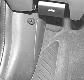 Locate the previously removed driver s side kick panel cover. 2. Drill a 9/32 hole at the top of the panel, approximately 2 down and 1.5 to the left edge of the access cover. (FIGURE T) 3.
