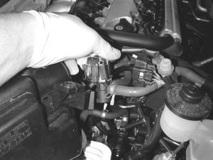 f) Remove the large vacuum line from the engine side of the