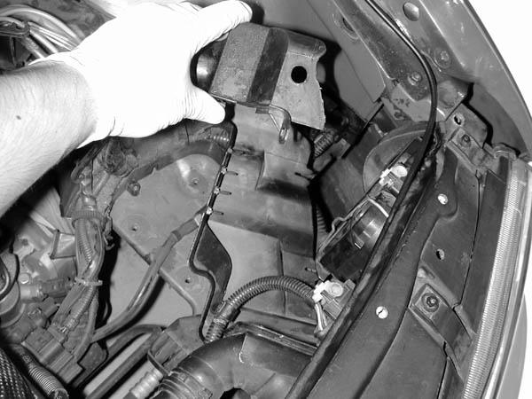 q) Pull the plastic guard from the engine bay.